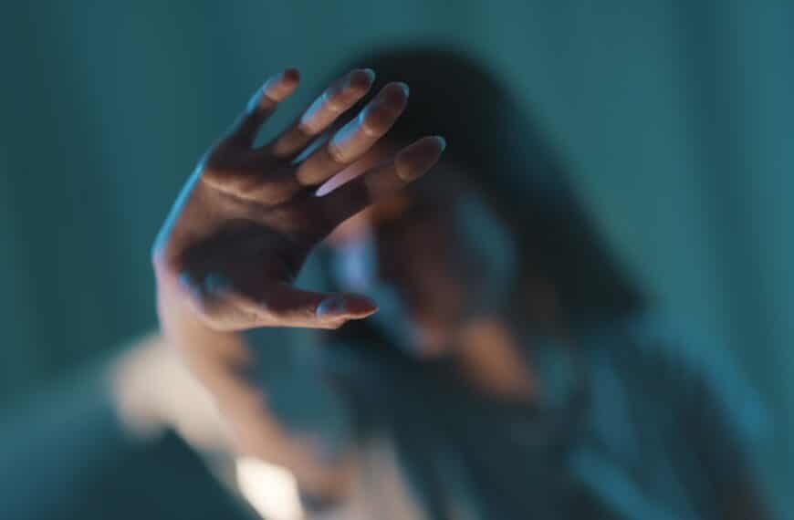 Young woman doing a stop sign with her hand