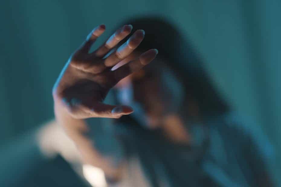 Young woman doing a stop sign with her hand